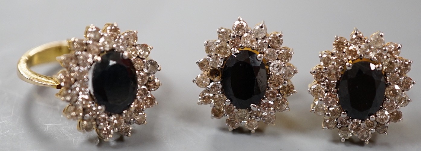 A modern suite of yellow metal, sapphire and diamond cluster set jewellery, comprising a ring, size H and a pair of earrings, 15mm, gross weight 10.4 grams.